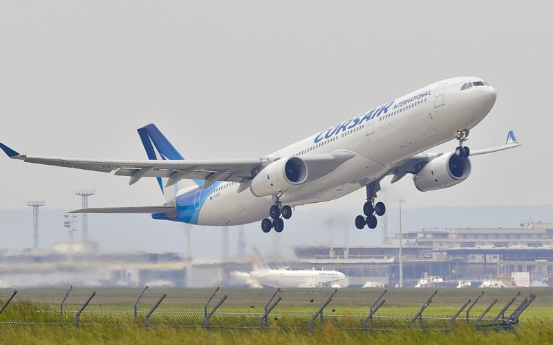 white and blue airplane about to fly at the airport